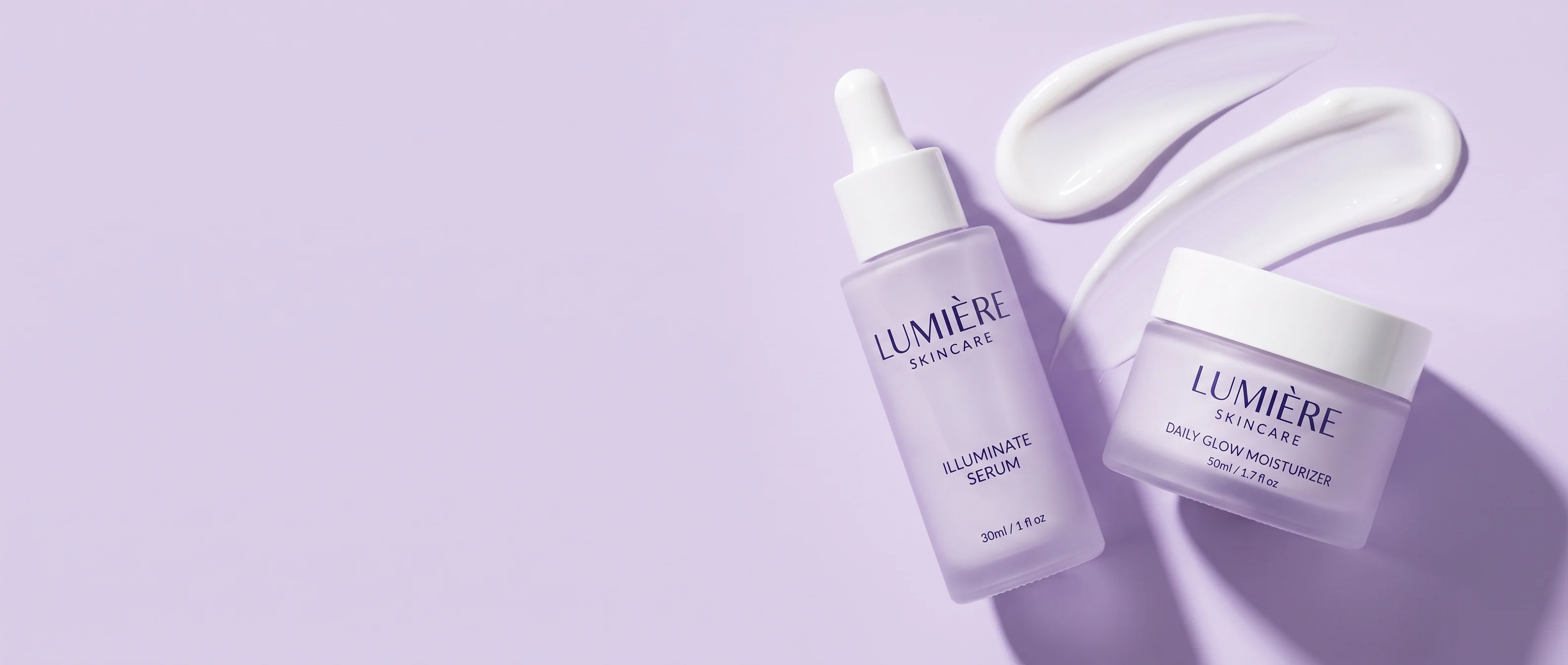 Illuminate Serum and Daily Glow Moisturizer on a lavender ground